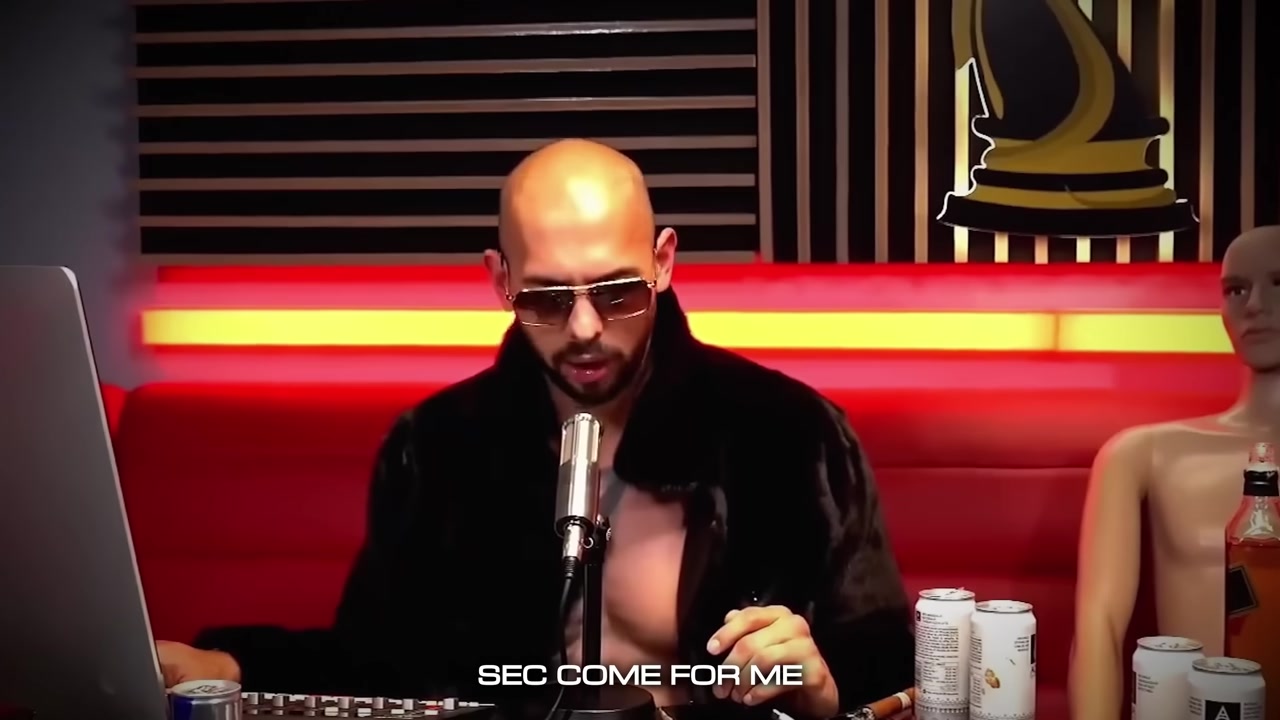 Andrew Tate, seated and wearing sunglasses, speaks into a microphone in a podcast-style set. A burned-in caption at the bottom of the frame reads SEC COME FOR ME.